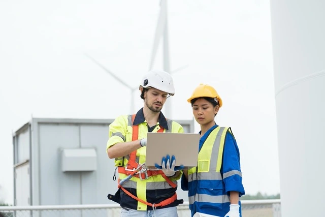 engineers looking at a computer on construction site